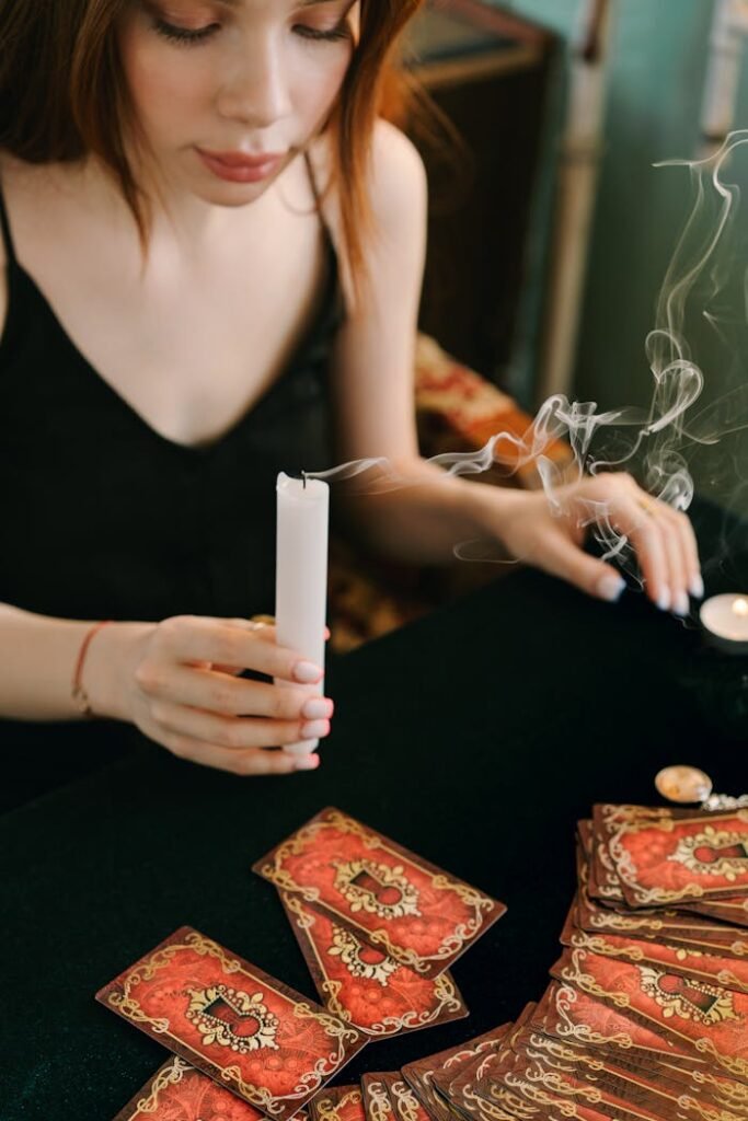 Woman in Black Tank Top Holding a Candle Stick